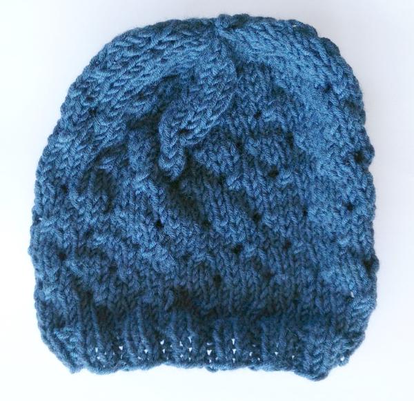 A blue hat with a lumpy spiral pattern.